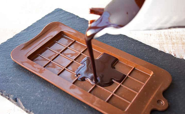 Using a spoon, fill your molds to 2/3-3/4 with the melted chocolate.